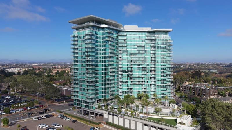 Glass High-Rise Residences at University Town Center Under Blue Skies