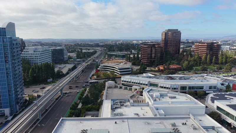 The Blue Line Trolley Threading Through University City’s Office District – Aerial View