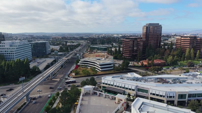 The Blue Line Trolley Threading Through University City’s Office District – Wide Establishing Frame