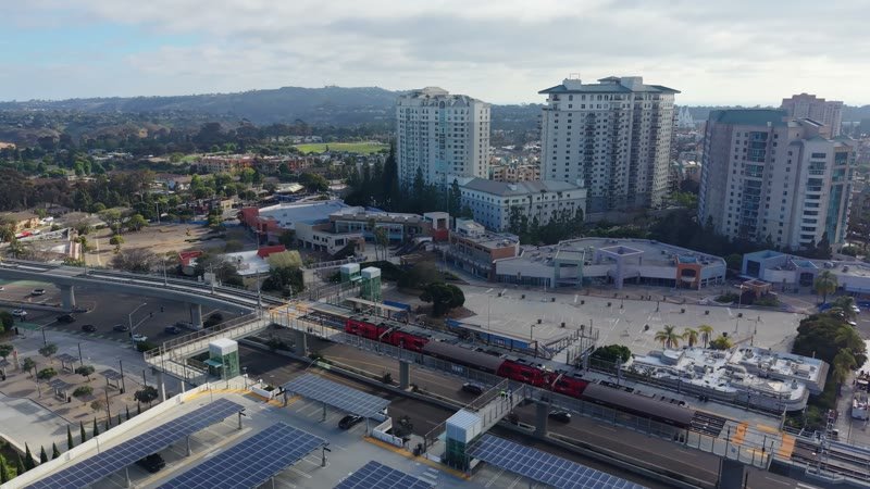 Trolley Arriving at the UTC Transit Center Below Residential Towers – Wide Establishing Frame