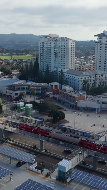 Trolley Arriving at the UTC Transit Center Below Residential Towers – Wide Establishing Frame (Vertical)